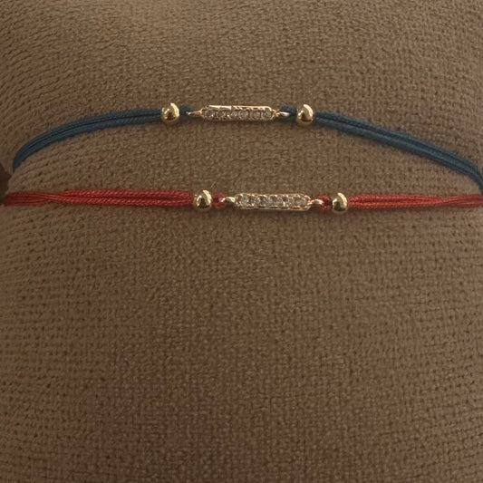 bracciale rose gold con barretta di zirconi bianchi e laccio rosso